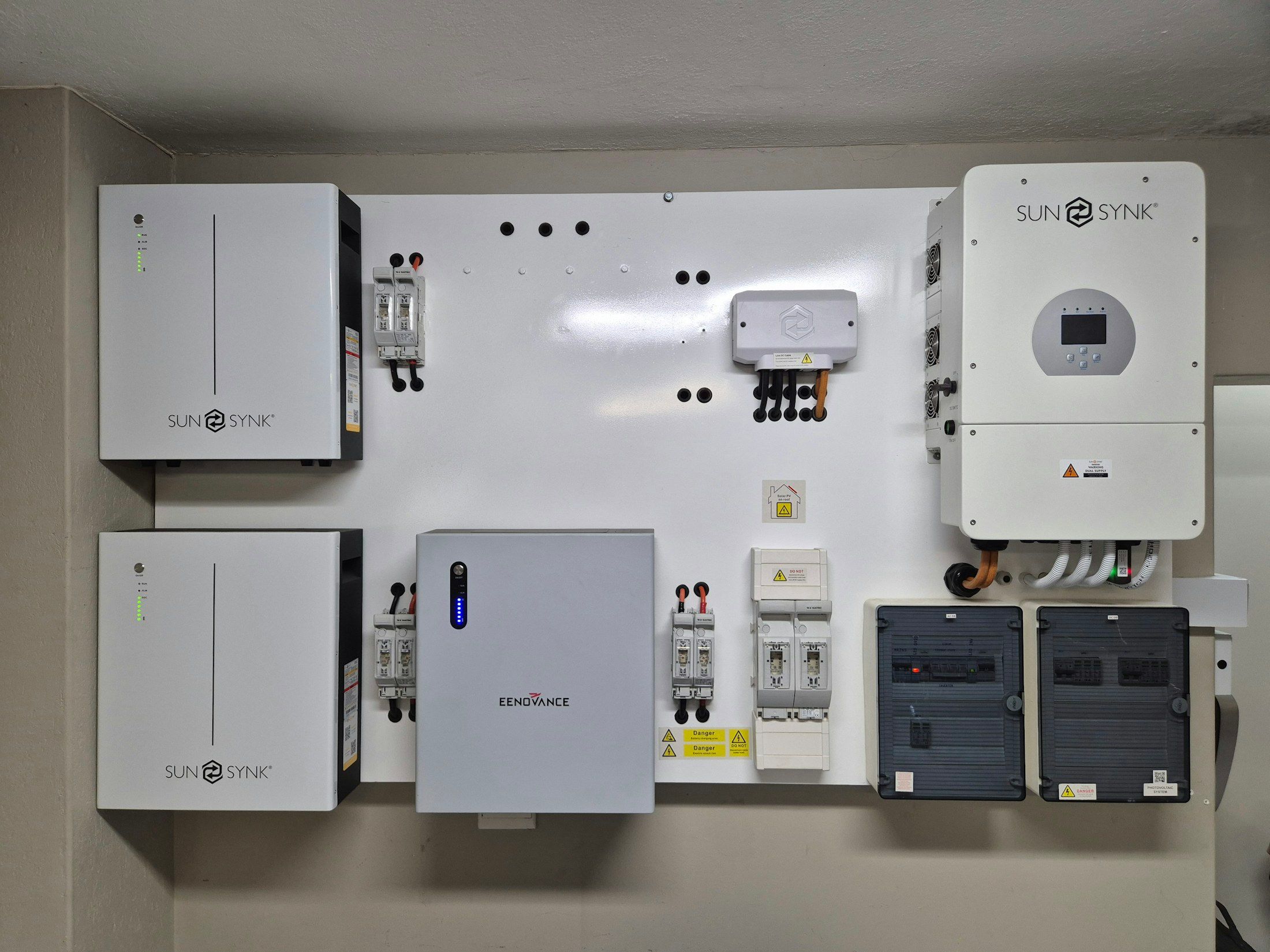 A home battery and inverter system mounted on a garage wall