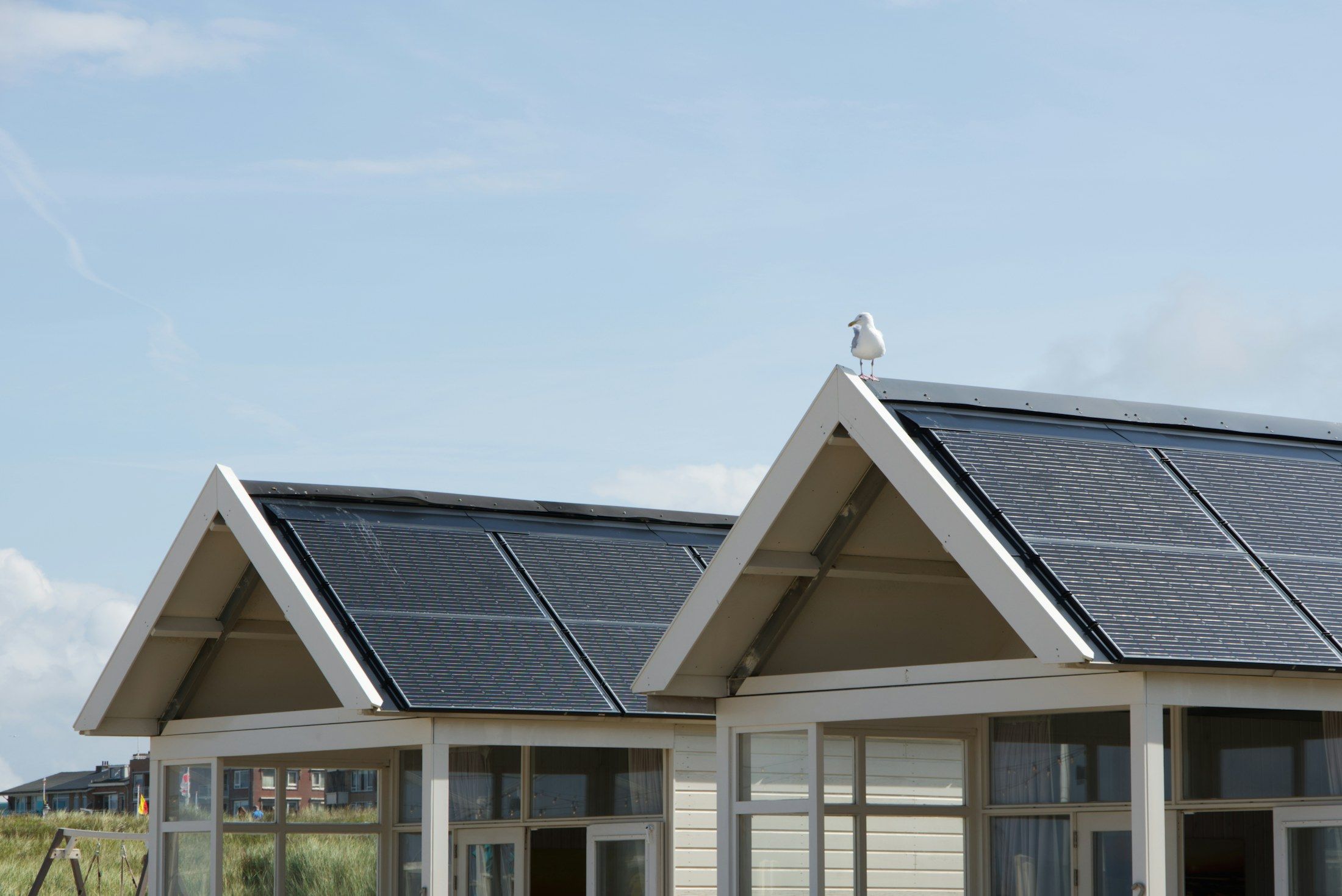 Two gabled houses with dark solar roofs