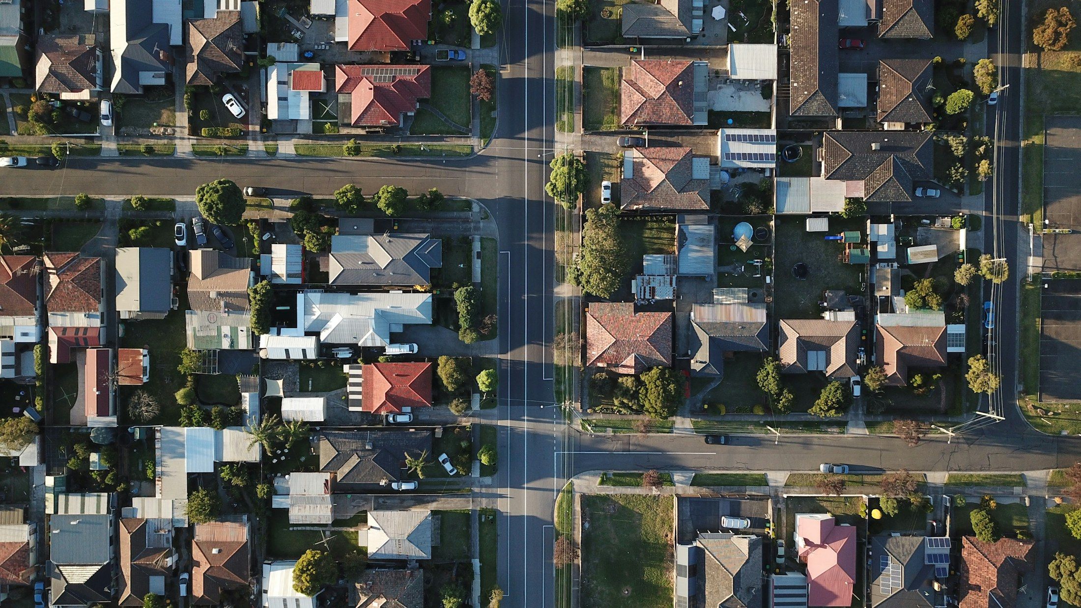 Aerial view of a suburb of red and grey roofs
